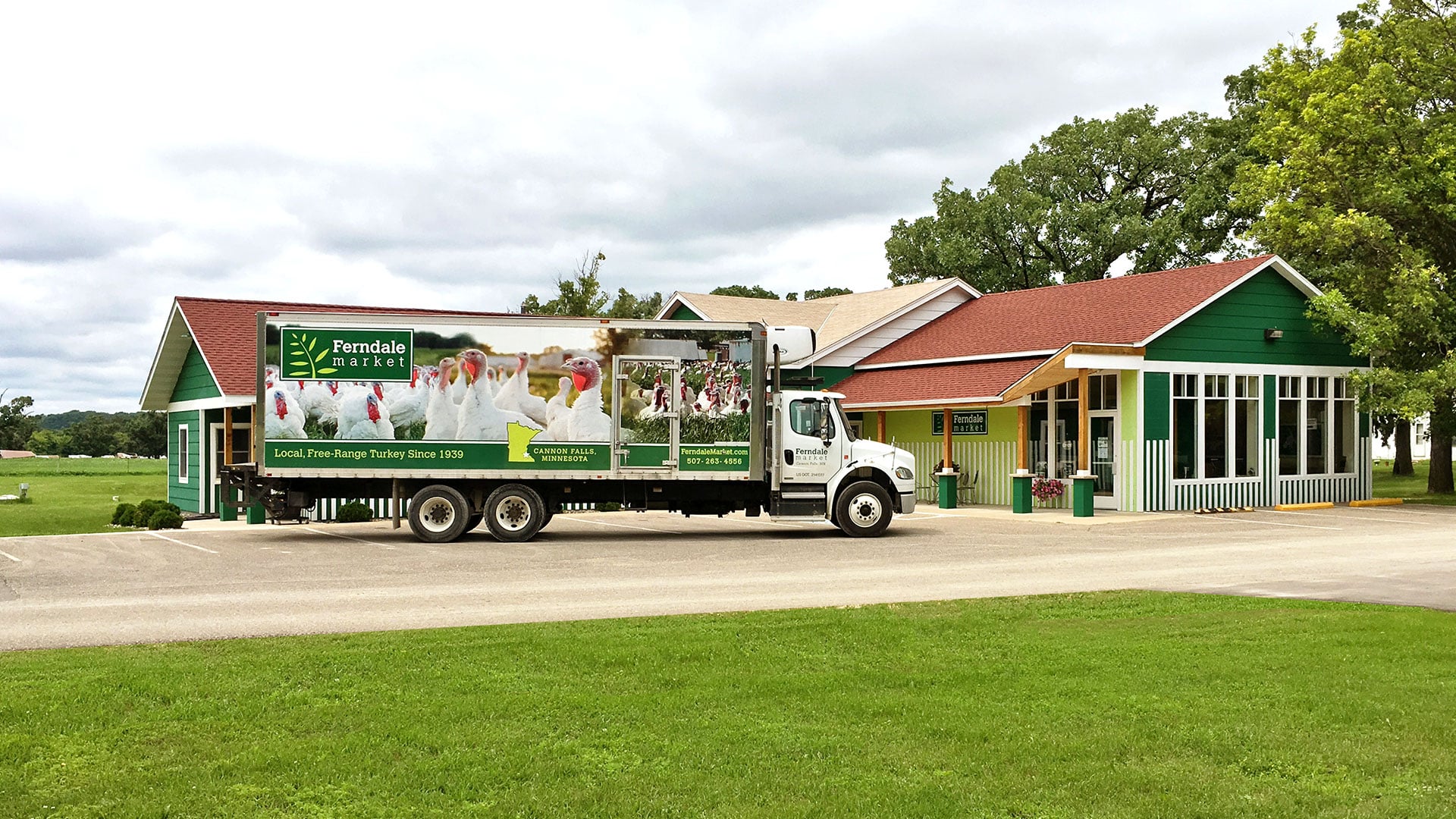 A Ferndale Market delivery truck parked outside of the main storefront